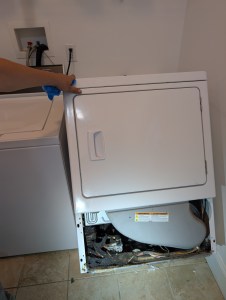 Technician testing ignition on a Speed Queen gas dryer that will not heat